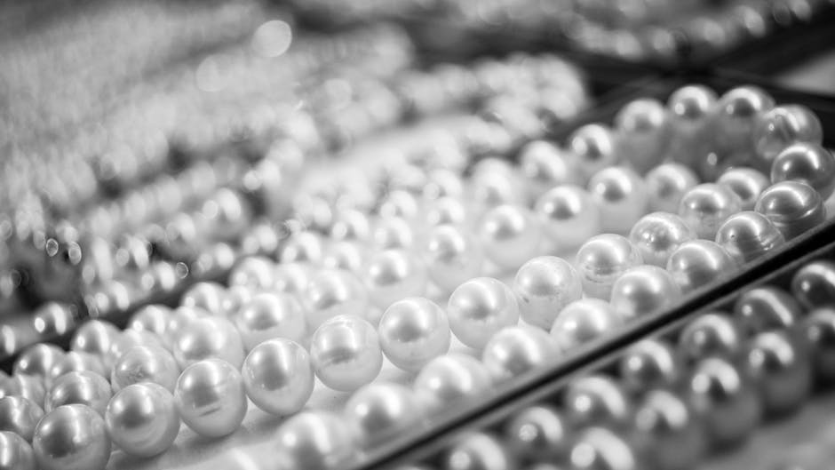 Pearls stored on a velvet-lined jewelry tray inside a wooden box with the lid slightly open