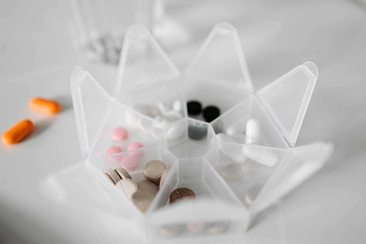 a seven-day pill organizer with rings in each compartment, closed and ready to pack