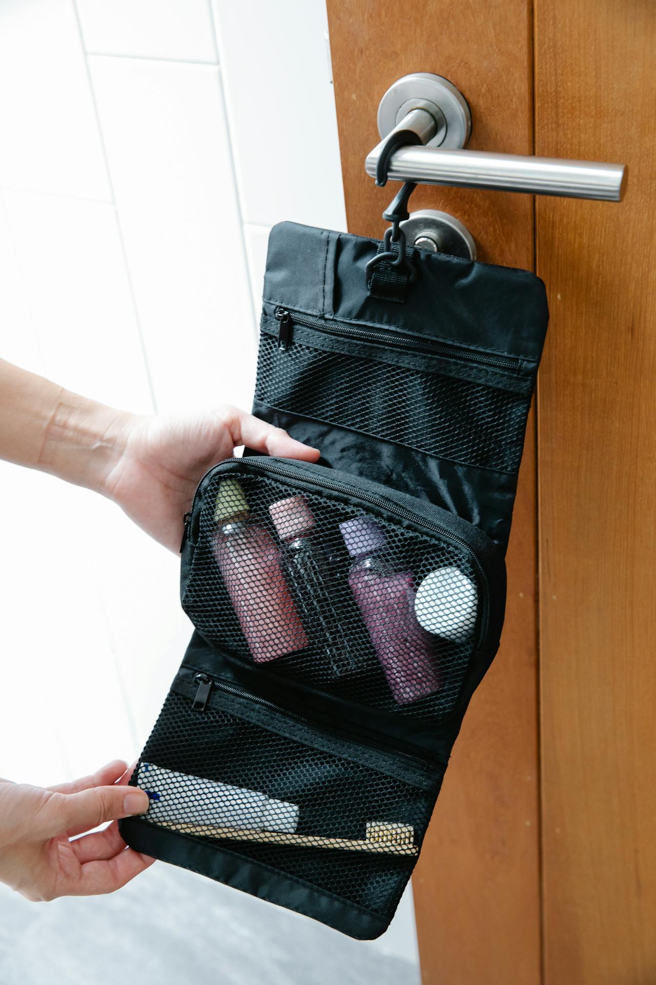 a small jewelry pouch zipped inside a carry-on tote bag, showing how little space it takes